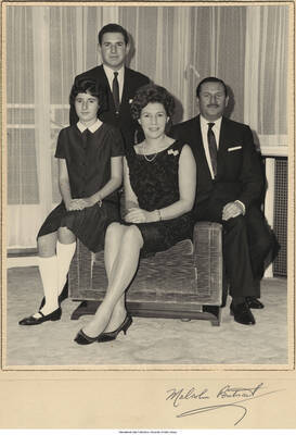 9 3/4 x 7 3/4 inch photograph inside a 14 x 10 inch folder; depicted is an unidentified family which includes father, mother, daughter, and son. Signed on the folder under the picture: Malcolm Pontnail