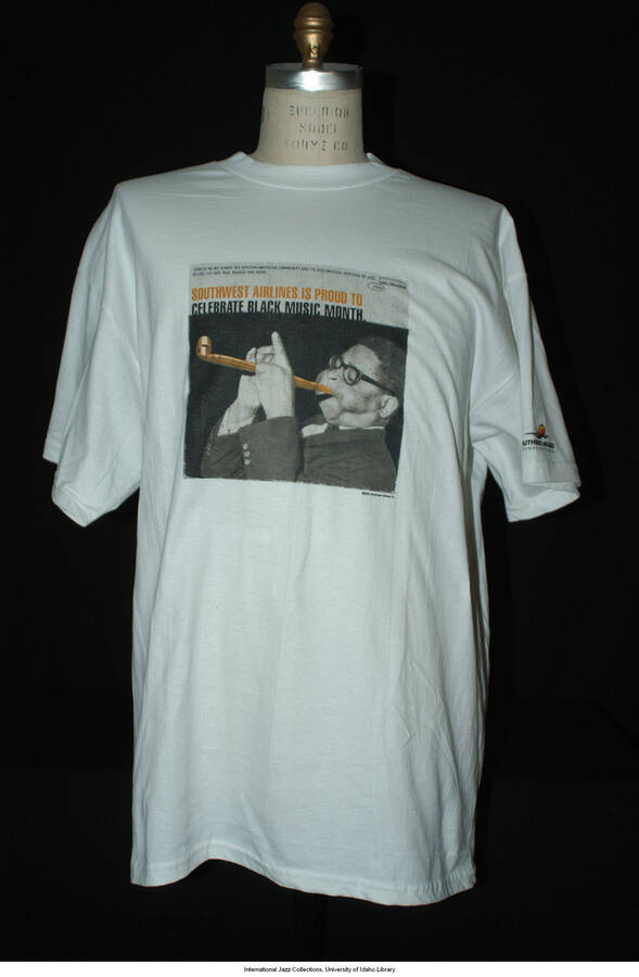 White, 100% cotton. CFD: gray, black, white, orange with photograph of D. Gillespie.  Text:"Southwest Airlines is Proud to Celebrate Black Music Month, June 1-June 30, 2000." Southwest Airlines logo on left sleeve hem.