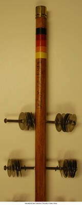 A four foot long rhythm stick inscribed with the name "Dizzy" on the haft.