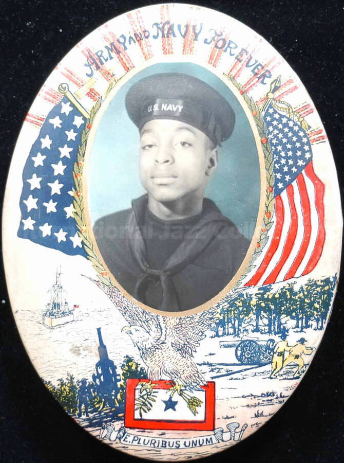 Portrait of Al Grey in military costume. The photograph is laid on a background depicting patriotic motifs. Inscribed above the photograph: Army and Navy Forever. The photograph and the background drawings occupy the complete front of this 8 x 6 inch oval metal frame