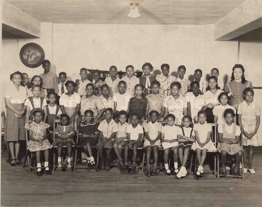 Unidentified group of children in what looks like a school pose, including unidentified adults, probably teachers