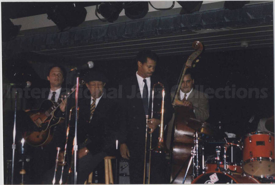 Al Grey with unidentified musicians on a stage