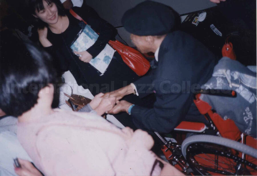 Al Grey in a wheelchair surrounded by fans [at Nakano Sunplaza], Tokyo