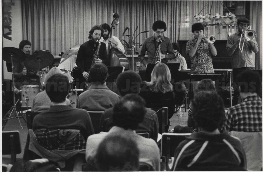 Unidentified musicians performing for an audience, [in a library?]