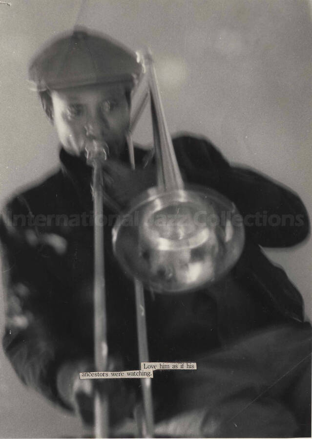 Unidentified trombonist. A printed cut out sentence glued on the photograph reads: Love him as if his ancestors were watching