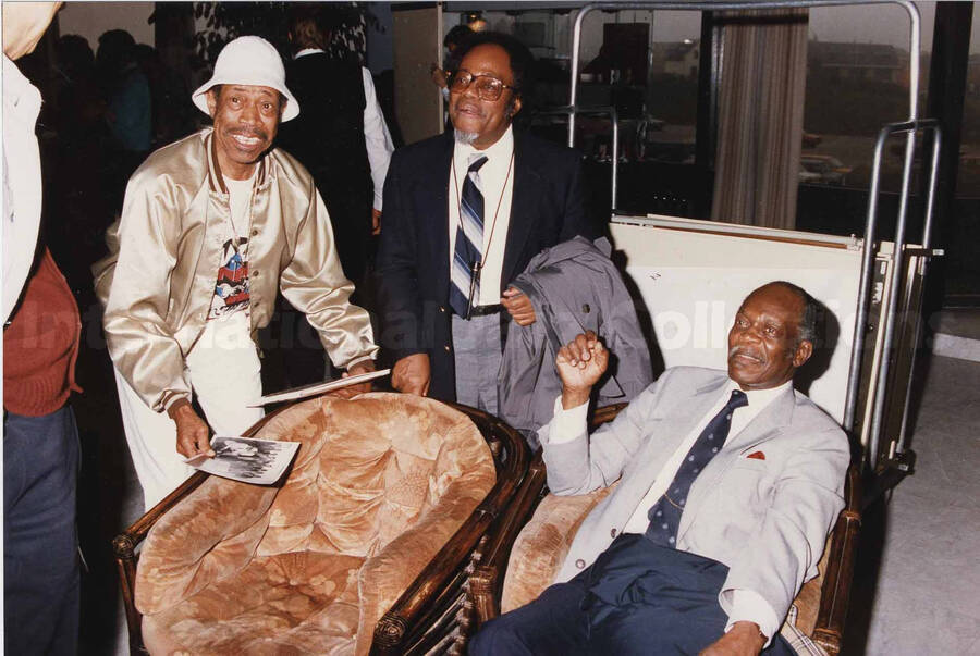 Al Grey posing with two unidentified men. A label on the back of the photograph reads: Sunday 1991-05-31. The Jazz Inn Party. Hotel "Huis ter Duin" - Noordwijk at Sea/Netherlands