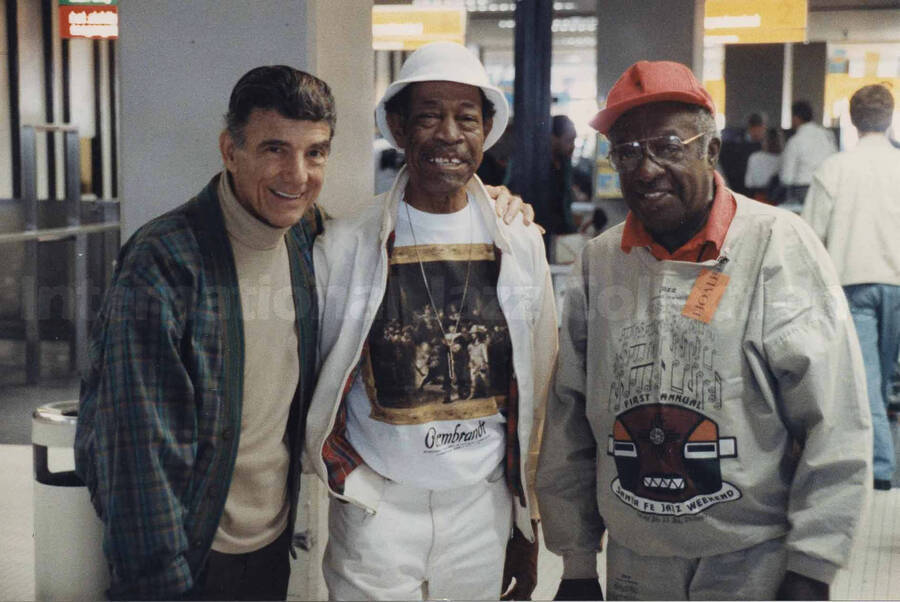 Al Grey posing with two unidentified men. A label on the back of the photograph reads: Sunday 14th, 1991. 16th North Sea Jazz Festival 1991/The Hague; Amsterdam Airport (Departure)