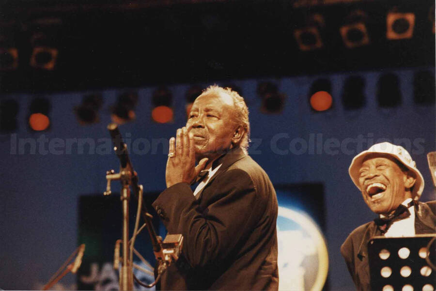 Harry "Sweets" Edison and Al Grey on stage. A label on the back of the photograph reads: Sunday 1994-07-10.  19th North Sea Jazz Festival/The Hague; Congress Centre/PWA-Hall [Golden Men of Jazz]