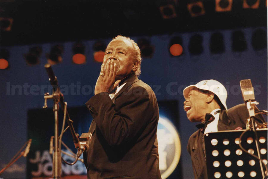 Harry "Sweets" Edison and Al Grey on stage. A label on the back of the photograph reads: Sunday 1994-07-10. 19th North Sea Jazz Festival/The Hague; Congress Building/PWA-Hall [Golden Men of Jazz]