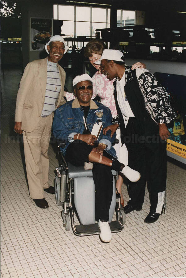 Al Grey, Clark Terry, Sophia Phillipson, and Bobby Durham. A label on the back of the photograph reads: Monday 1994-07-11. 19th North Sea Jazz Festival/The Hague [Golden Men of Jazz]; Amsterdam Airport [Departure hall] "Schiphol"