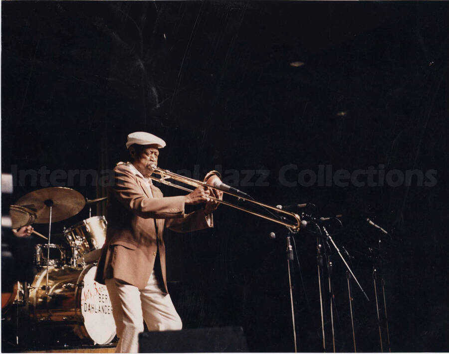 Al Grey playing the trombone. Partially seen on the stage is a drum with the name: Bert Dahlander