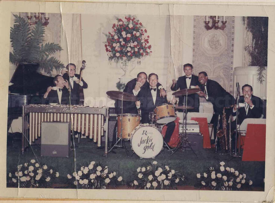 Al Grey and unidentified musicians. This photograph is pasted on a photo album sheet.
