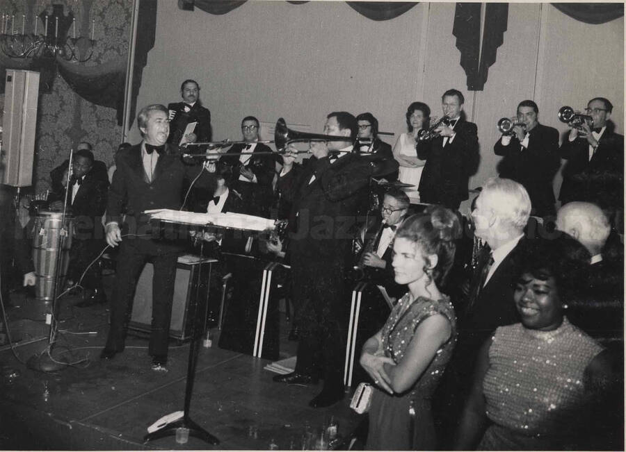 Al Grey performing with an unidentified band at the inaugural ball of the Pennsylvania Governor Milton Shapp. This photograph is pasted on a photo album