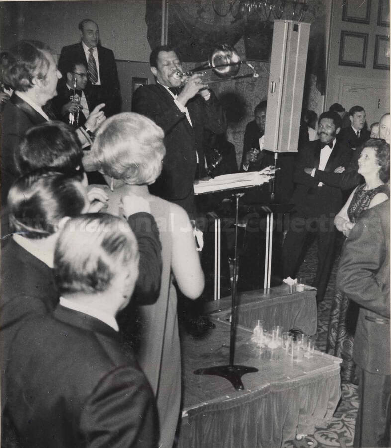 Al Grey performing a solo at the inaugural ball of the Pennsylvania Governor Milton Shapp, 1971-01. This photograph is pasted on a photo album