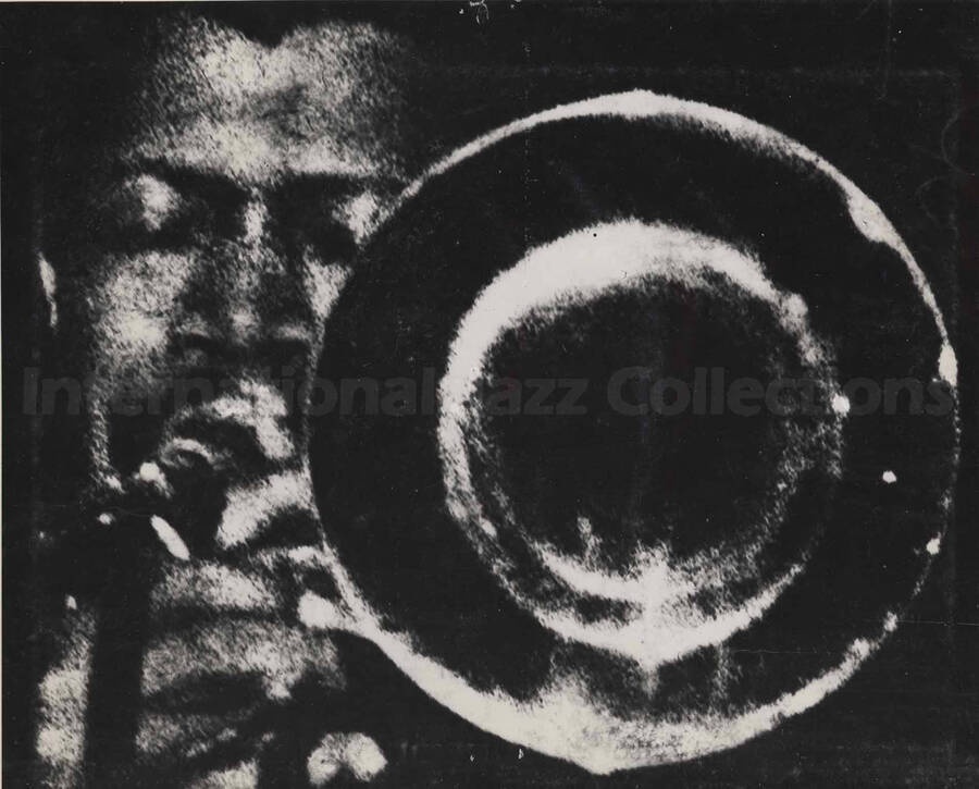 Al Grey playing the trombone. This photograph is pasted on a photo album