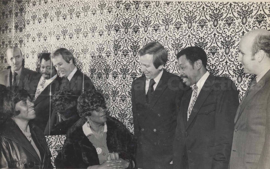 Al Grey, Ella Fitzgerald, and unidentified persons. This photograph is pasted on a photo album