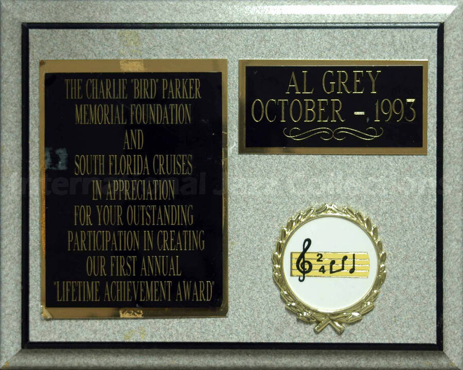 Wood finish plaque with two double engraved plate and a disk. To Al Grey from the Charlie ""Bird"" Parker Memorial Foundation and South Florida Cruises, in appreciation for his participation in creating the first annual ""Lifetime Achievement Award""