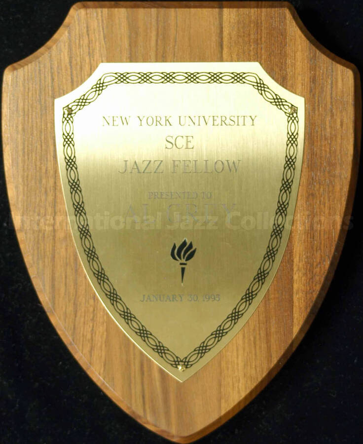 Shield walnut finish plaque with engraved plate. New York University - SCE Jazz Fellow presented to Al Grey