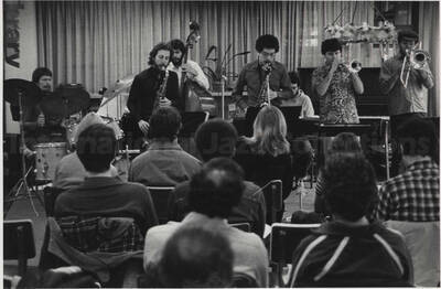 Unidentified musicians performing for an audience, [in a library?]