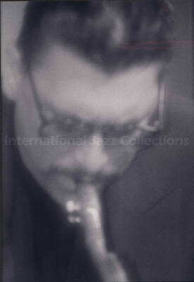 Unidentified musician. The photograph is mounted on a black mat. Handwritten on the mat bellow the photograph: Bill Kreisberg, "Sexy Sax";  1996