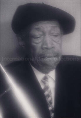 Al Grey. The photograph is mounted on a black mat. Handwritten on the mat bellow the photograph: Bill Kreisberg "Contemplation";  1996