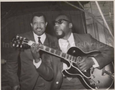 Al Grey posing with unidentified guitarist. This photograph is pasted on a photo album