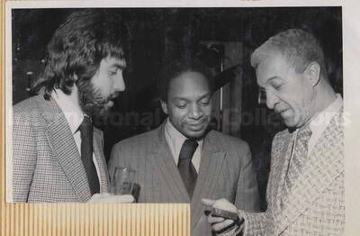 Al Grey with unidentified men. This photograph is pasted on a photo album.