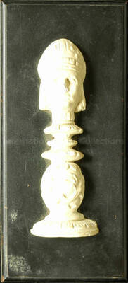 Wood finish plaque holding a figure in ceramic. Stamped on the back of the plaque: J. H. Hunsicker Mfg. Co., Water Valley (MS)