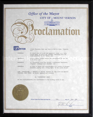 Frame holding a cloth certificate under glass. To Al Grey from the University of Idaho for his contribution to the Lionel Hampton-Chevron Jazz Festival