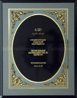 Wood finish plaque with engraved plate. To Al Grey from the Fish Middleton Jazz Scholarship Fund for his encouragement to young artists, at the 5th Annual East Coast Jazz Festival. A label on the back of the plaque reads: American Presentations, Cox Industries, Silver Spring (MD)