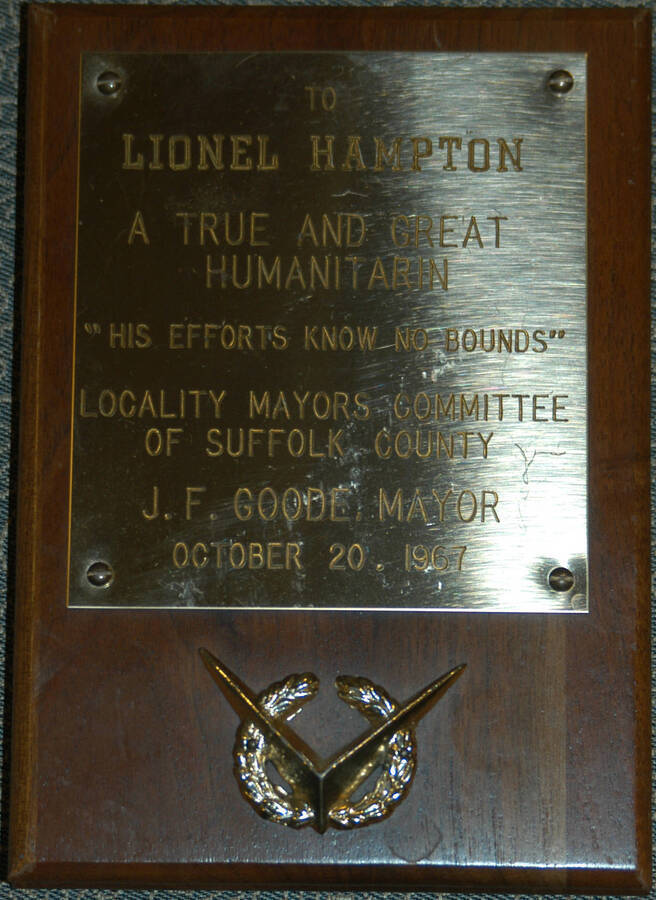 Plaque. 7"x5" Wood finish plaque with wreath and engraved plate To Lionel Hampton from the locality mayors committee of Suffolk County. J. F. Goode, Mayor. [New York, NY], Oct. 20, 1967