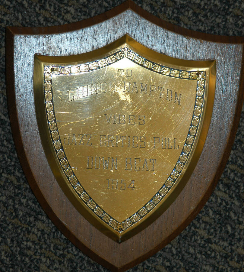 Plaque. 7 1/2"x6 1/2" Shield wood finish plaque with engraved plate To Lionel Hampton from the Vibes Jazz Critics Poll Down Beat. 1954
