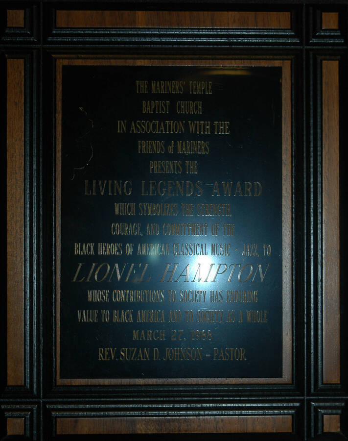 Plaque. 10"x8" Wood finish squared border plaque with  black engraved plate Living Legends Award presented to Lionel Hampton by the Mariner's Temple Baptist Church in association with the Friends of Mariners, for his contributions to black America and to society as a whole. Rev. Suzan D. Johnson, Pastor. [New York, NY], Mar. 27, 1988