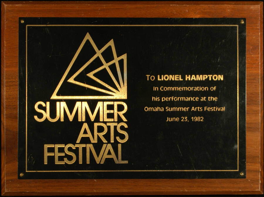 Plaque. 9"x12" Wood finish plaque with engraved plate To Lionel Hampton for his performance at the Omaha Summer Arts Festival. [Omaha, NE], June 23, 1982
