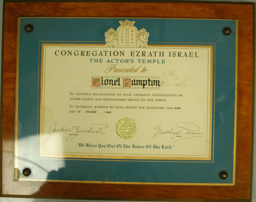 Certificate Plaque. 9"x12" Certificate with gold foil seal, mounted under acrylic on a 11"x141" wood plaque To Lionel Hampton from the Actor's Temple of the Congregation Ezrath Israel in grateful recognition of his distinguished service to the temple. Moshay Mann, Rabbi. New York, NY, July 4, 1960