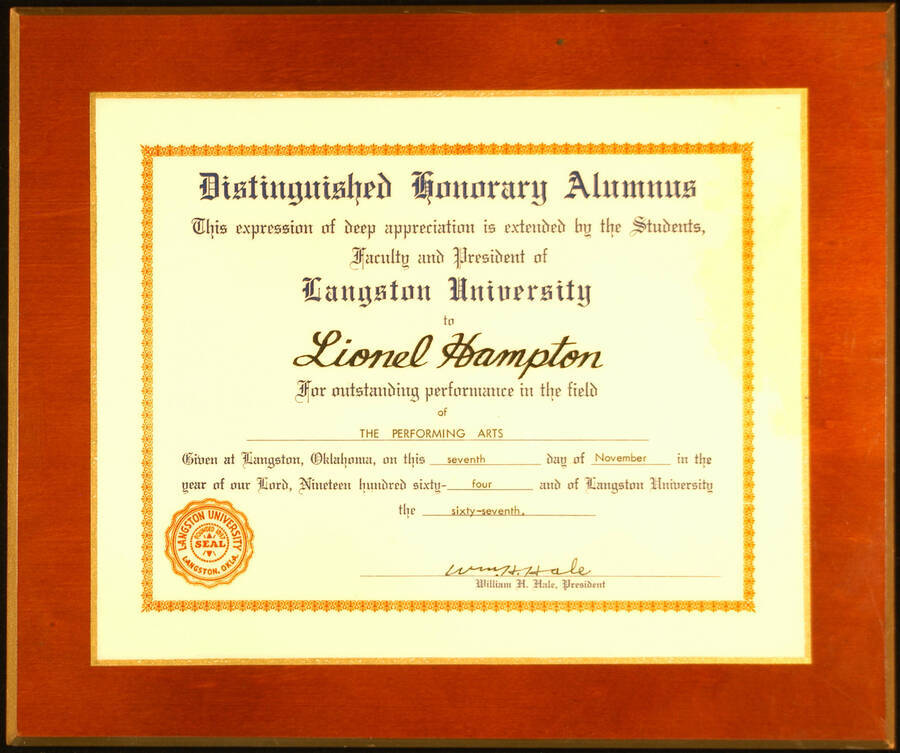 Certificate Plaque. 8"x10" Certificate laminated on a 10 1/4"x12 3/4" wood plaque Certificate of Distinguished Honorary Alumnus presented to Lionel Hampton by Langston University for outstanding performance in the field of the performing arts. William H. Hale, President. Langston, OK, Nov. 7, 1964