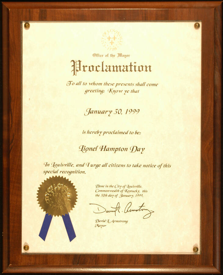 Certificate Plaque. 11"x8 1/2" Proclamation with gold foil seal and blue ribbon, mounted under acrylic on a 13"x10 1/2" wood plaque City of Louisville proclaims January 30, 1999 as Lionel Hampton Day. David L. Armstrong, Mayor. Louisville, KY, Jan. 30, 1999