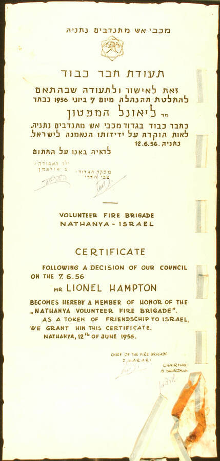 Certificate and Scroll. 7 1/2"x16 1/4 Hebrew/English certificate bearing a light blue and white ribbon finishing with a wax seal on the right. Also a green scroll with a bilingual label Title of Member of Honor presented to Lionel Hampton by the Nathanya Volunteer Fire Brigade for his friendship to Israel. Z. Harari. Nathanya, Israel, June 12, 1956