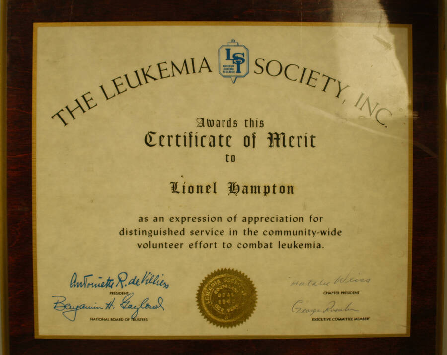 Certificate Plaque. 10"x12" Certificate with gold foil seal laminated on a 12 1/2"x14 1/2" wood plaque Certificate of Merit presented to Lionel Hampton by the Leukemia Society for his distinguished service in the community-wide volunteer effort to combat leukemia. [New York, NY, 194_?]