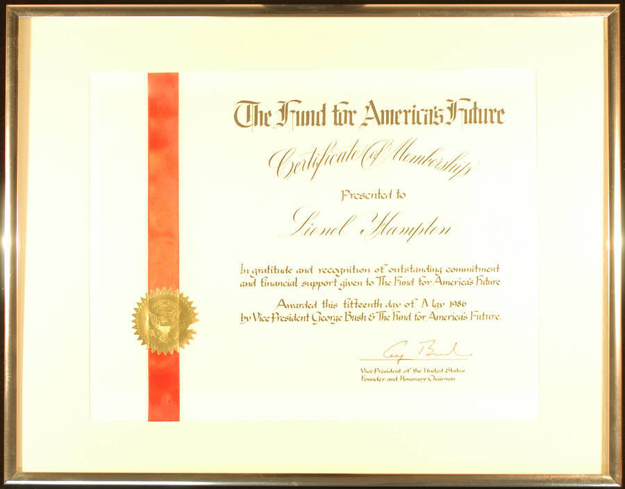 Framed Certificate. 14 1/2"x 18 1/2" Aluminum frame holding a 10 1/2"x13 1/2" certificate with a red ribbon on the left bearing a gold foil seal on white mat under glass Certificate of Membership presented to Lionel Hampton by the Fund for America's Future for his commitment and financial support. George Bush, Vice President of the United States, Founder and Honorary Chairman. May 15, 1986
