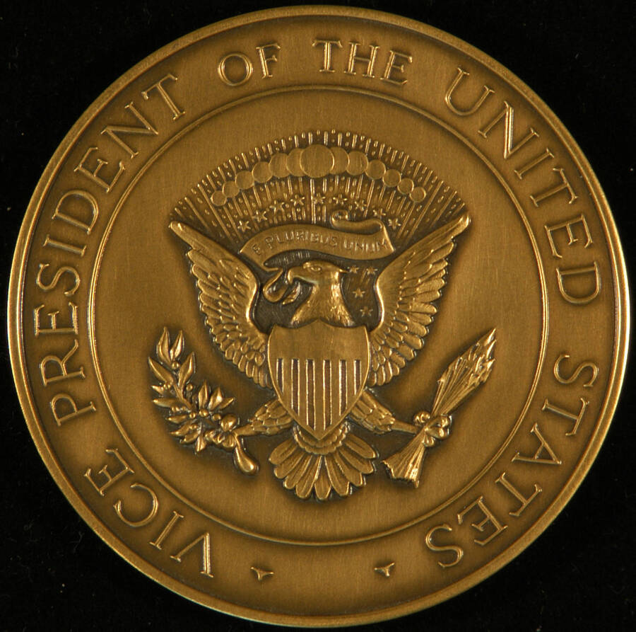 Medal. 3" Bronze medal depicting the Seal of the Vice President of the United States and, on the reverse, the engraved autograph of George Bush.  On the edge it reads "1985 Medallic Art co. Danbury, CT". It is inside a blue hard plastic box with the seal on top.