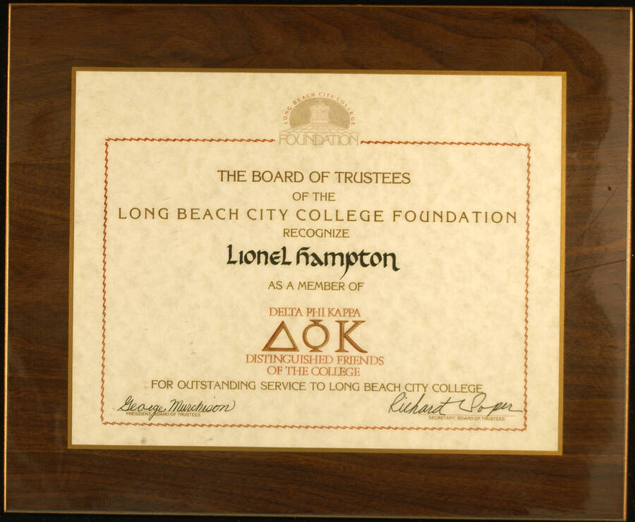 Certificate Plaque. 8 1/2"x11" Certificate laminated on a 11 1/2"x14"  wood plaque Title of member of Delta Phi Kappa Distinguished Friends of the College presented to Lionel Hampton by the Board of Trustees of the Long Beach City College Foundation for outstanding service to the College.