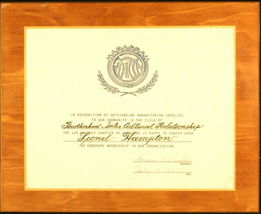 Certificate Plaque. 8 1/4"x10 3/4" Certificate laminated on a 11"x13 1/2" wood plaque Honorary Membership presented to Lionel Hampton by the Los Angeles Chapter of Hadassah in recognition of outstanding humanitarian services to the community. Florence A. Ravitch, President. Los Angeles, CA,  July 12, 1960
