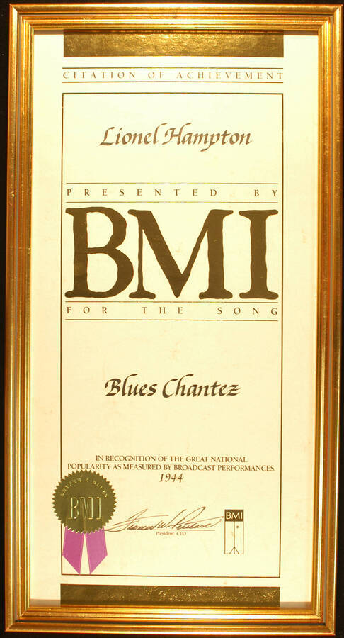Framed Certificate. 20"x10" Certificate with gold foil seal and purple ribbon in an 21 1/4"x11 1/4" frame with glass Citation of Achievement presented to Lionel Hampton by BMI for the song Blues Chantez in recognition of the great national popularity as measured by broadcast performances. 1944