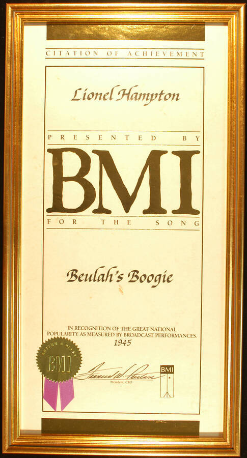 Framed Certificate. 20"x10" Certificate with gold foil seal and purple ribbon in an 21 1/4"x11 1/4" frame with glass Citation of Achievement presented to Lionel Hampton by BMI for the song Beulah's Boogie in recognition of the great national popularity as measured by broadcast performances. 1945