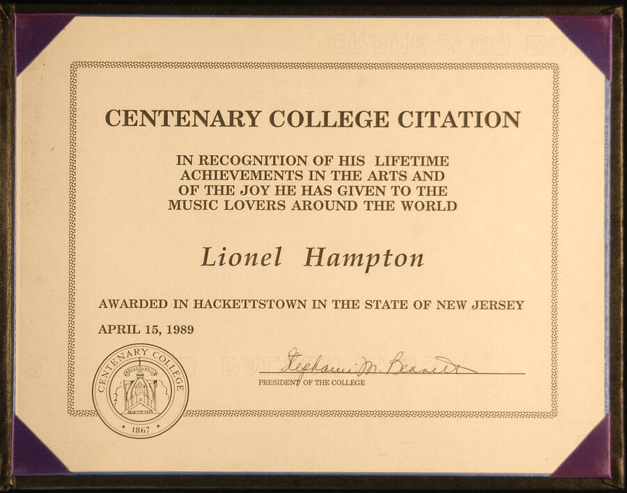 Certificate. 8 1/2"x11" Certificate under clear plastic inside an 9 1/4"x11 3/4" black folder. The cover of the folder has the name of the college printed in gold To Lionel Hampton from Centenary College for his achievements in the Arts. Stephanie M. Bennett, President. Hackettstown, NJ, Apr. 15, 1989