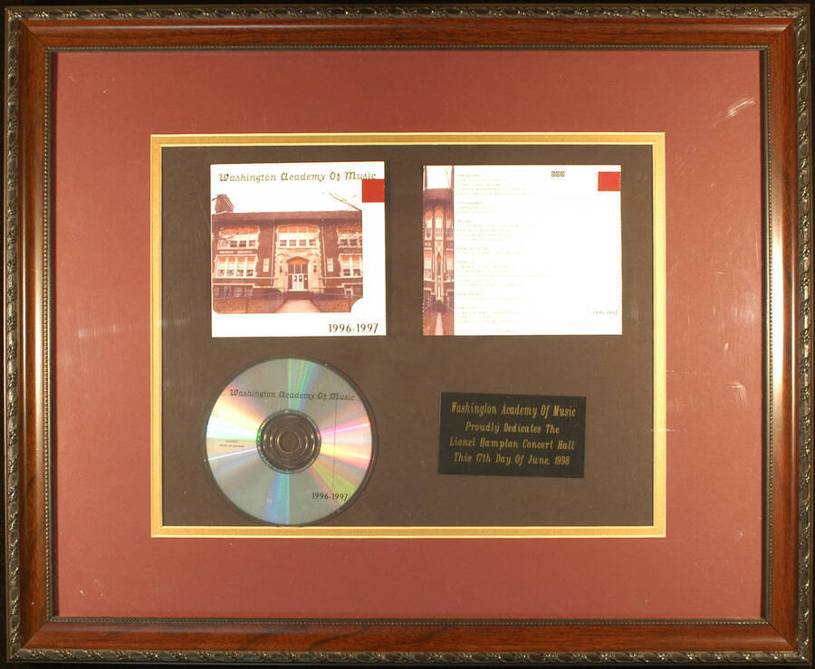 Plaque. 18"x22 1/4" Framed board displaying a Compact Disc and its cover, from Washington Academy of Music, 1996-1997, and 2 1/4"x4" engraved plate Washington Academy of Music proudly dedicates the Lionel Hampton Concert Hall. East Orange, NJ, June 17, 1998