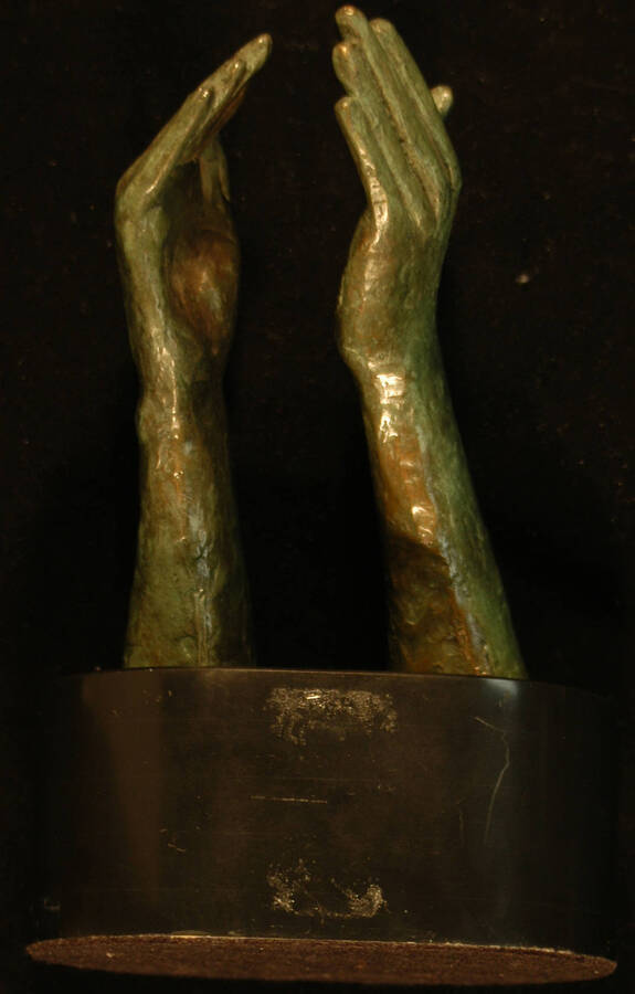 Trophy.  7 1/2"x5 1/2" Trophy composed by two bronze hands reaching out from the base