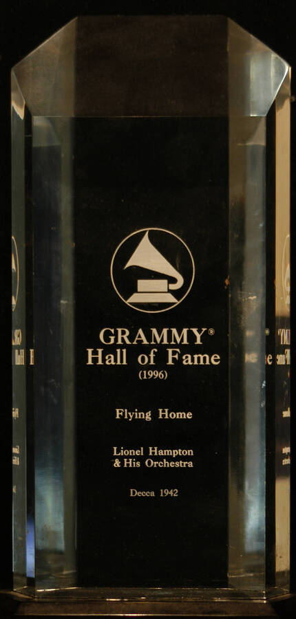 Plaque. 9"x4 1/4" Clear acrylic engraved plaque on 1"x5 1/2" black acrylic base Grammy Hall of Fame presented to Lionel Hampton and His Orchestra by the National Academy of Recording Arts and Sciences-NARAS, for "Flying Home." 1996