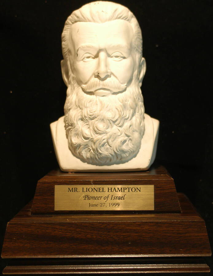 Trophy. 7 1/2"x4 1/2" Bust with the inscription "Theodor Herzl, the founder of Zionism" on the back and "Don Winton" on the left. 3 1/2"x8" wood base with engraved plate To Lionel Hampton, Pioneer of Israel. June 27, 1999